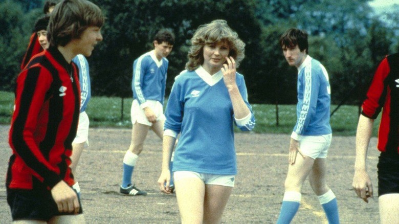 Dorothy in soccer uniform amidst the male players
