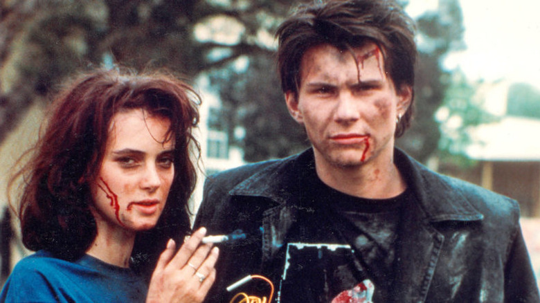 Winona Ryder and Christian Slater disheveled and covered in blood