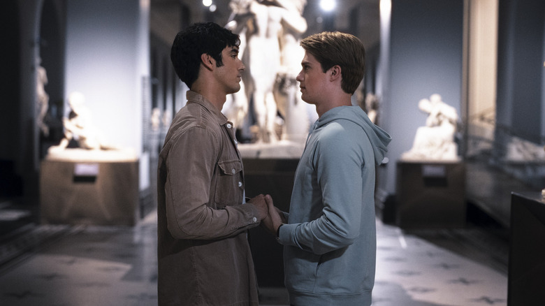 Alex and Henry in a museum holding hands in Red White & Royal Blue
