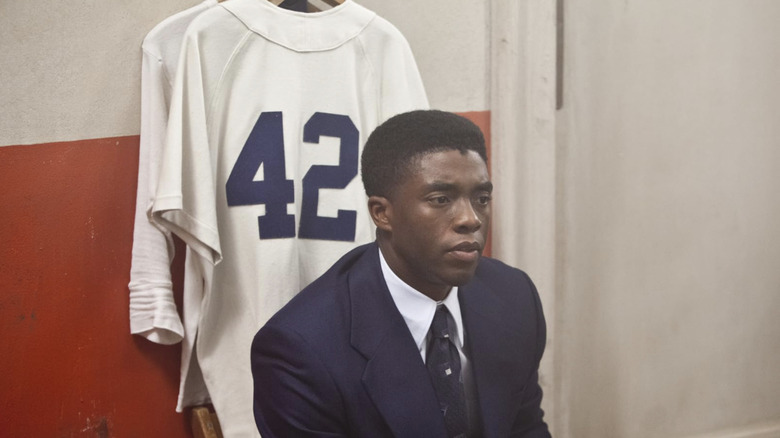 Chadwick Boseman as Jackie Robinson sitting in locker room in 42
