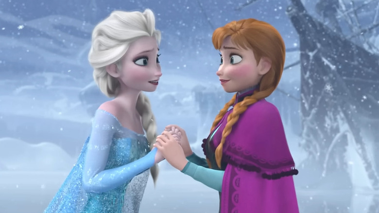 Anna and Elsa holding hands in "Frozen"