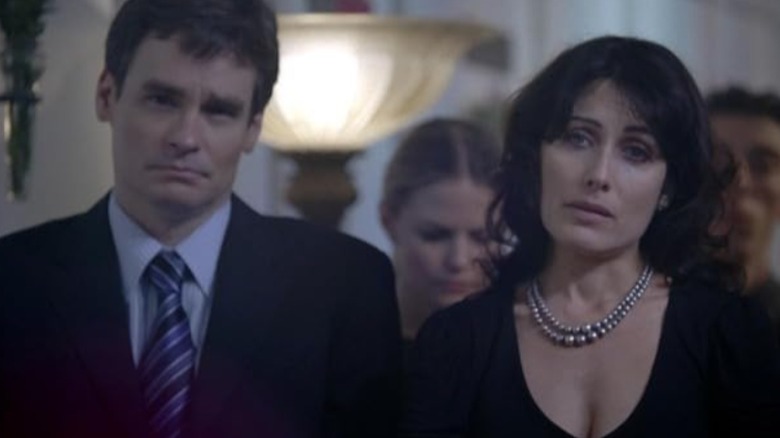 Wilson sits next to Lisa Cuddy at a funeral on House MD (2004 - 2012)