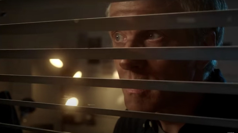 Reese Getty looking out his window