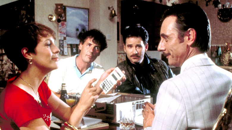 Wanda, Ken, Otto, and George sit at a table in 'A Fish Called Wanda' (1988)