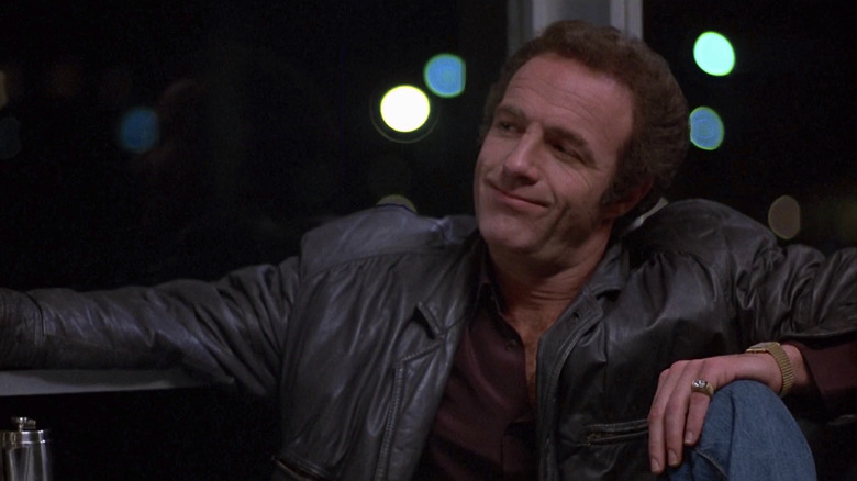 Frank sits in a diner smirking in 'Thief' (1981)