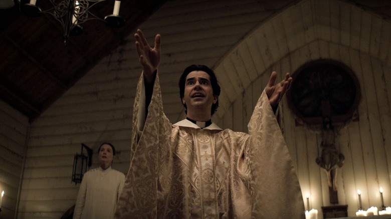 Father Hill preaches to his congregation in "Midnight Mass" (2021)