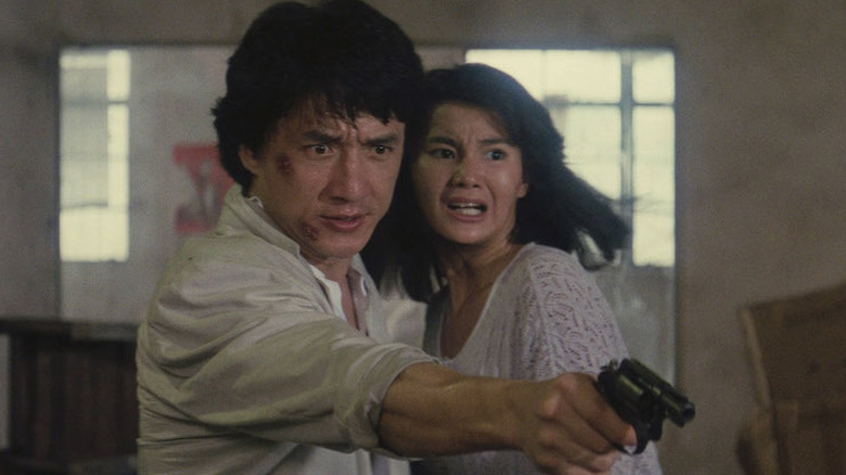May stands scared near Ka-Kui as he points a gun in Police Story 2