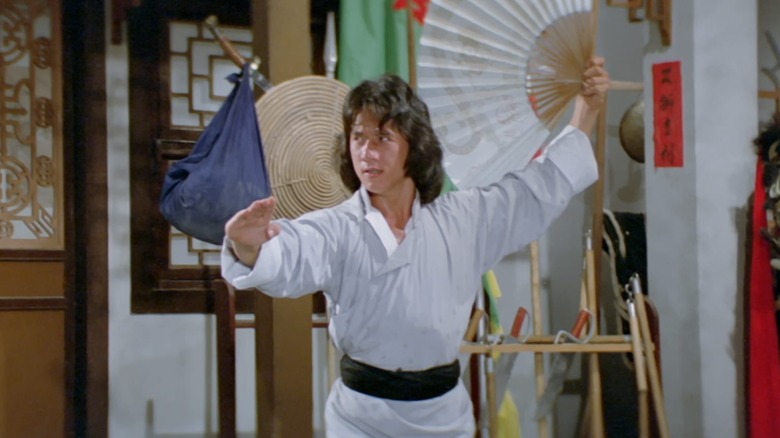 Dragon poses with a fan in The Young Master