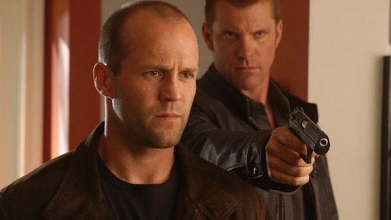 Greer enters a house while a henchman aims a gun in "Cellular" (2004)