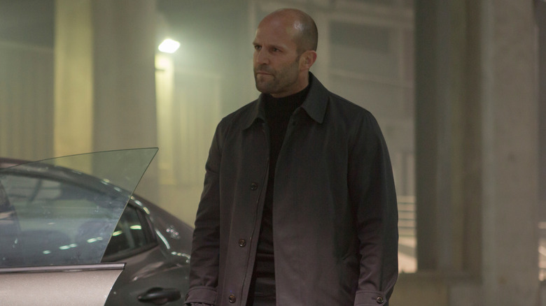 Deckard Shaw stands next to his car in "Furious 7" (2015)