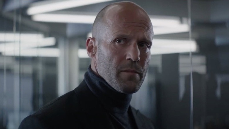 Shaw turns and looks over his shoulder in "Hobbs and Shaw" (2017)