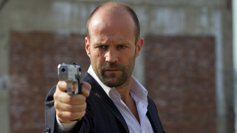 Wright aims a gun in "Safe" (2012)