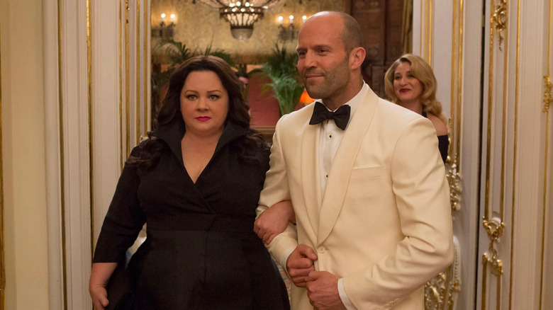 Rick and Susan walk into a fancy ballroom in "Spy" (2015)