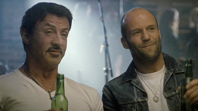 Barney and Christmas have a beer together in "The Expendables 2" (2012)