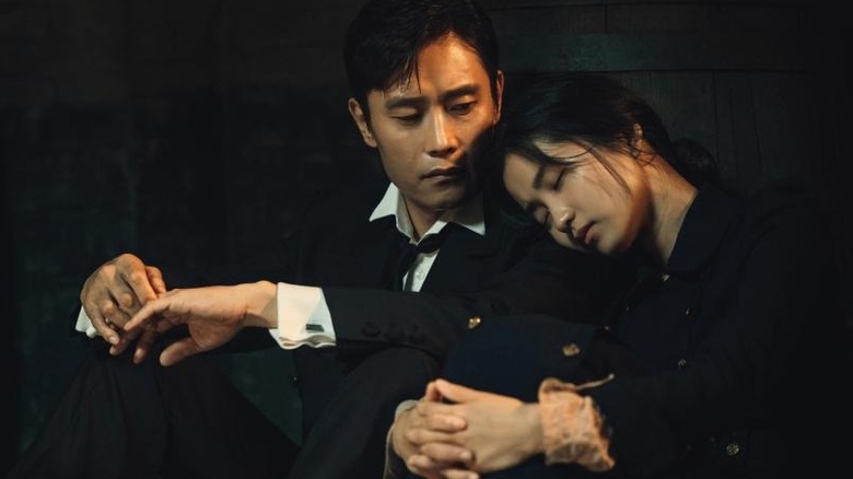 Choi Yu-jin looks down at a sleeping Go Ae-shin in Mr. Sunshine (2018)
