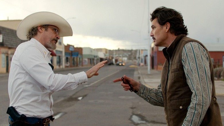 Joe and Ted argue in the street in Eddington
