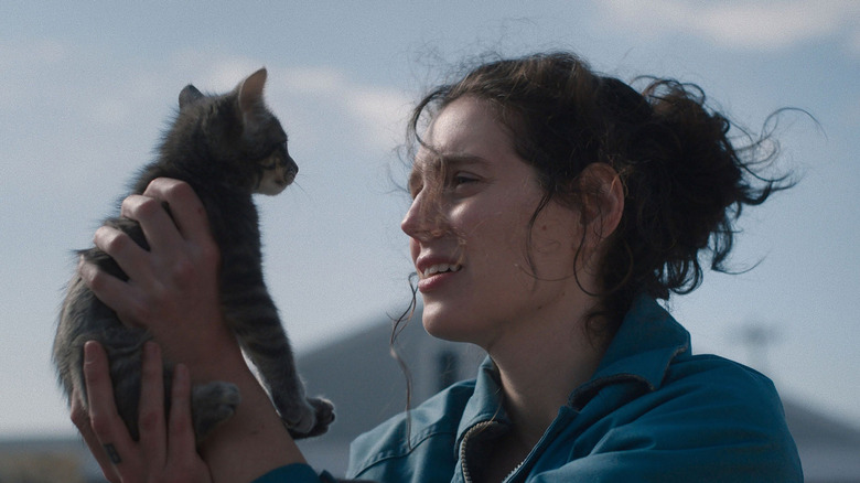 Agnes holds up a cat in Sorry, Baby