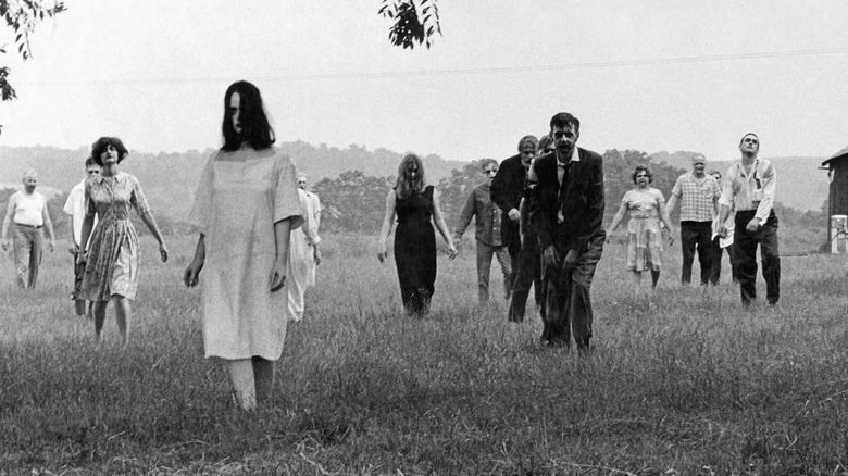 Zombies walk through a field in "Night of the Living Dead" (1968)