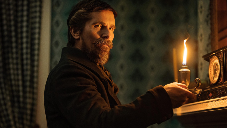 Landor holds up a candle in The Pale Blue Eye