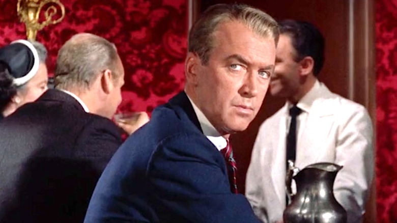 Ferguson sits at the bar and looks over his shoulder in Vertigo.