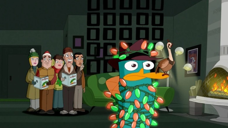 Perry tied up with Christmas lights next to a group of carolers in Phineas and Ferb