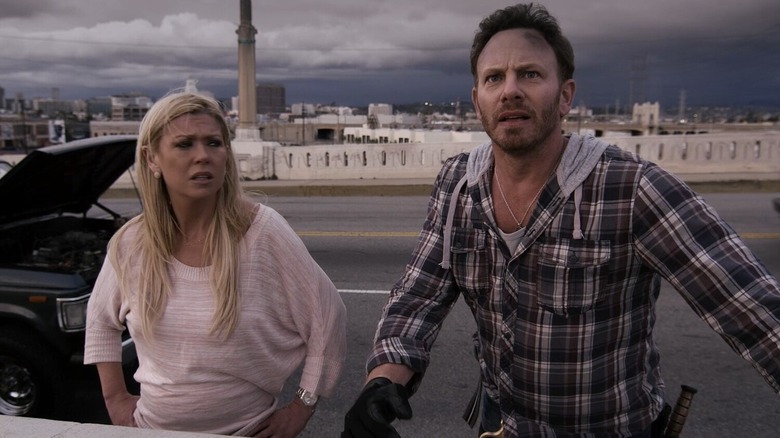 April and Fin with stormy skies behind them in "Sharknado"