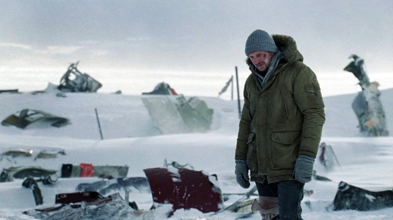 John Ottway walking through snow-covered wreckage in "The Grey" (2011)