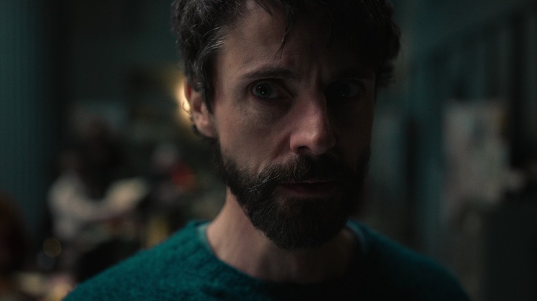 DCI Carl Morck standing with a concerned look on his face in "Dept. Q"
