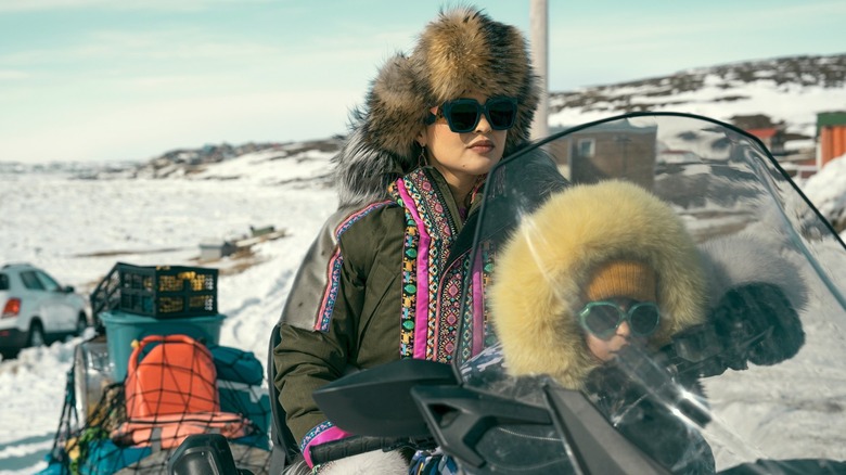 Siaja and her daughter riding a snowmobile in "North of North"