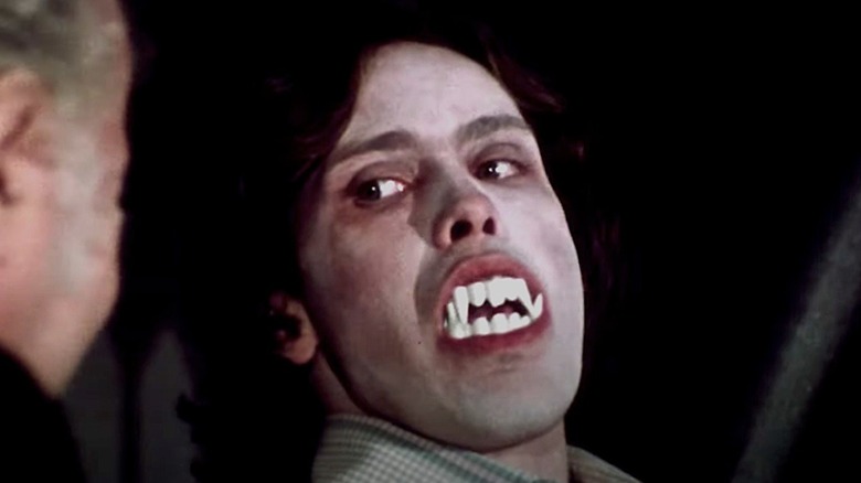Martin wearing fake vampire teeth to scare his cousin in "Martin"