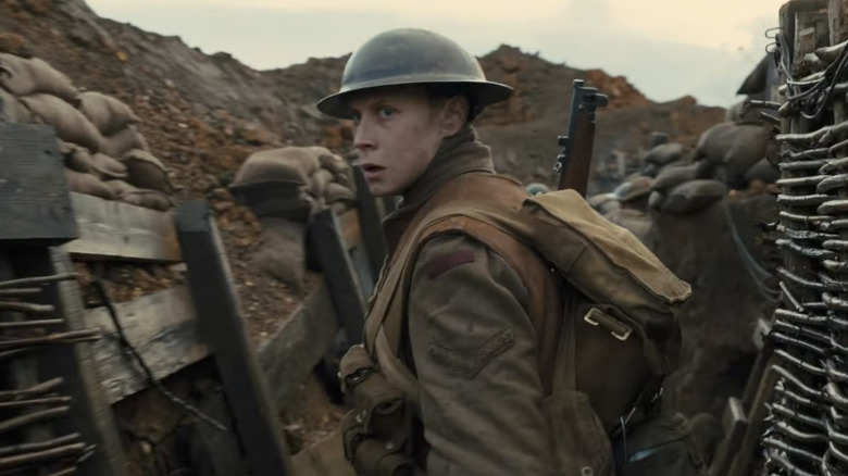 William looks over his shoulder in the trenches in 1917 (2019)