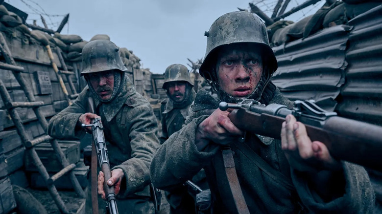 Paul leads a pair of soldiers through the trenches in All Quiet on the Western Front (2022)
