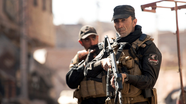 Jasem and Kawa survey the street in Mosul (2019)