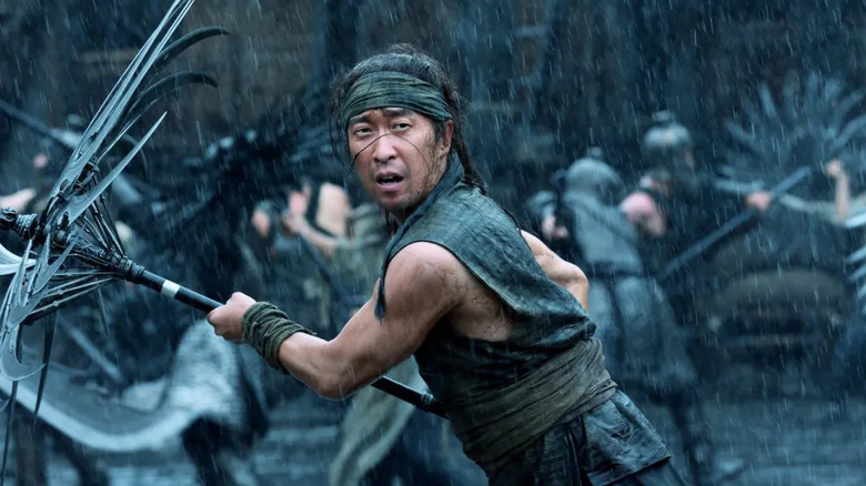 The warrior swings his staff in the rain in Uprising (2024)
