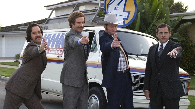 Brian, Ron, Champ, and Brick pointing at camera in front of news van (2004)