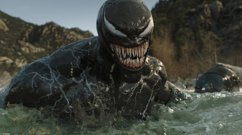 Venom snarling as he walks through water (2024)