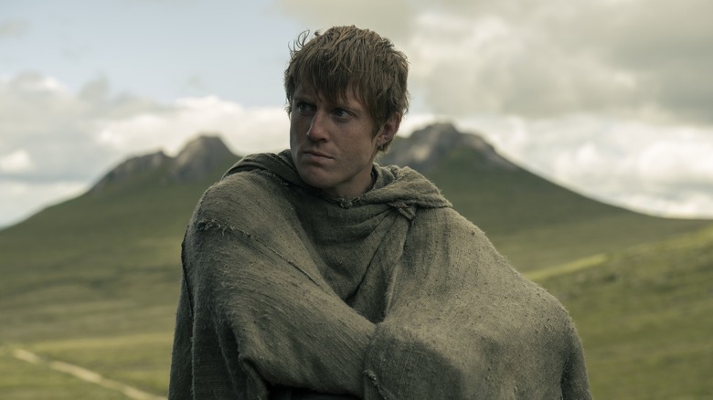 Ser Duncan the Tall huddling in a blanket on a hillside in A Knight of the Seven Kingdoms (2026)