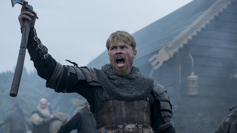 Eric Bloodaxe raising his axe during a war cry in Bloodaxe (2027)