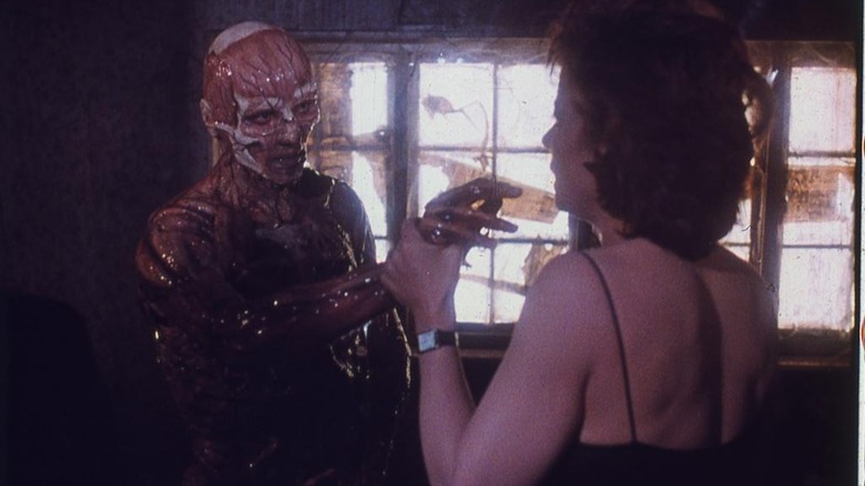 A skinless Frank reaches out to touch Julia in "Hellraiser" (1987)