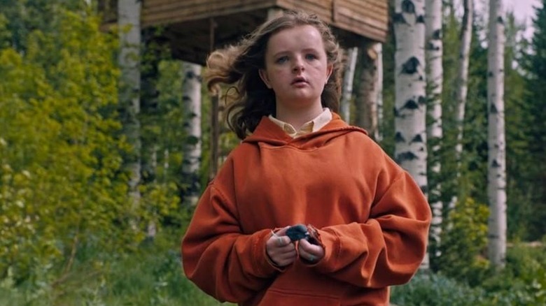 Charlie picks up a stone in "Hereditary" (2018)