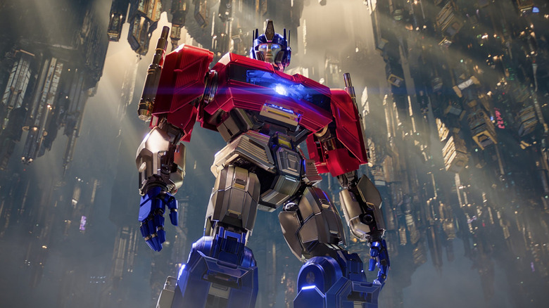 Chris Hemsworth's Optimus Prime standing in complex alien cityscape in Transformers One