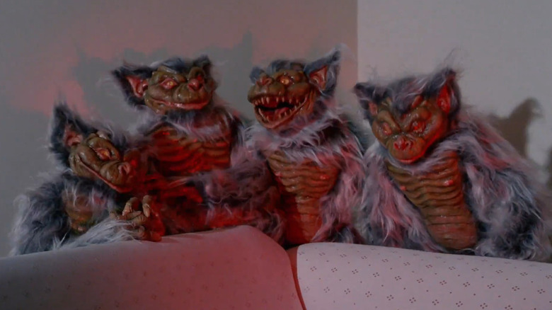 The title creatures huddle on a couch in "Hobgoblins" (1988)