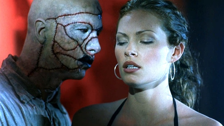 A zombie priest leers at Alicia in "House of the Dead" (2003)