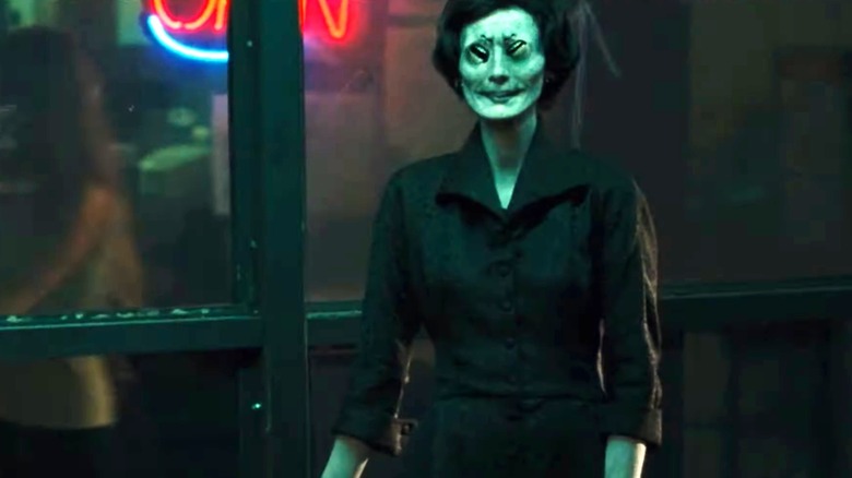A ghostly woman has mouths for eyes in "One Missed Call" (2008)