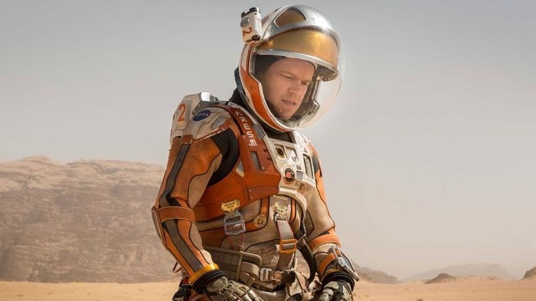 Mark Watney kneeling on Mars in The Martian