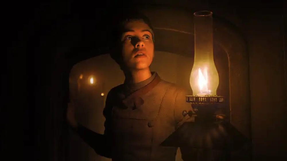 Sophia Lillis raising a lantern