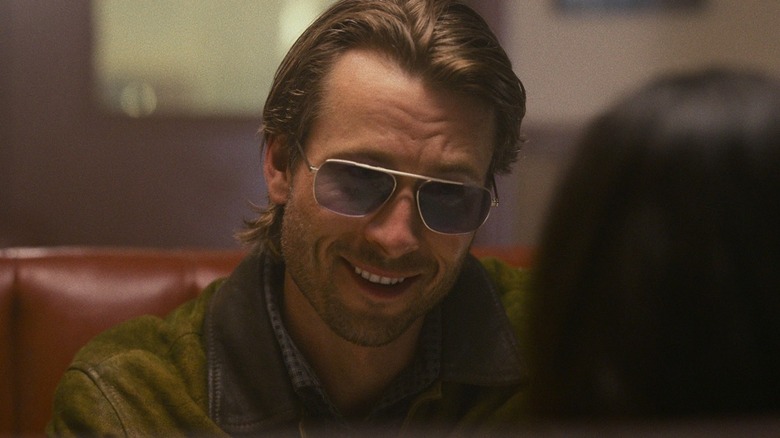 Gary Johnson sits at a diner table in "Hit Man" (2023)