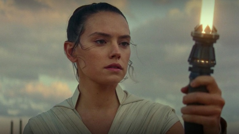 Rey looking at her new lightsaber in "Star Wars: The Rise of Skywalker"