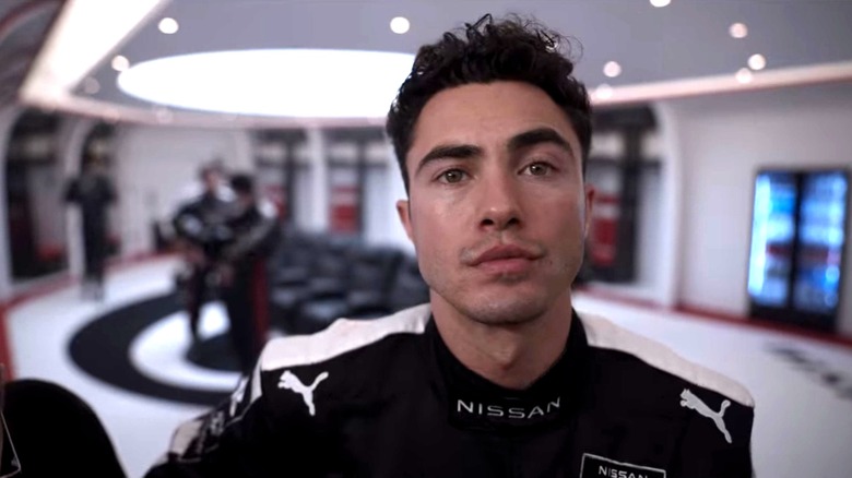Darren Barnet as Matty wearing a driver suit in Gran Turismo