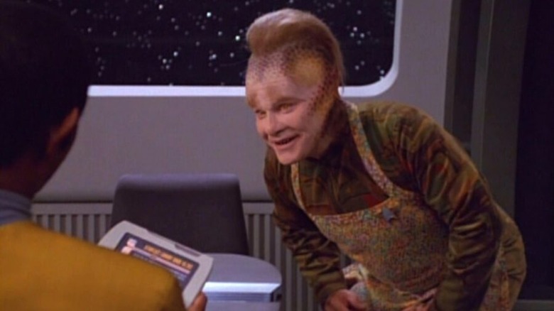 Neelix bends and smiles at Tuvok in Star Trek: Voyager